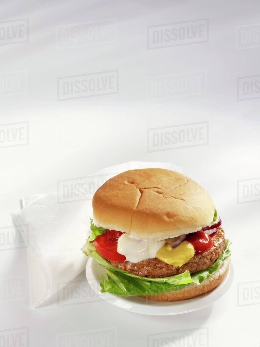 A hamburger with mustard, ketchup and mayonnaise Stock Photo Dissolve