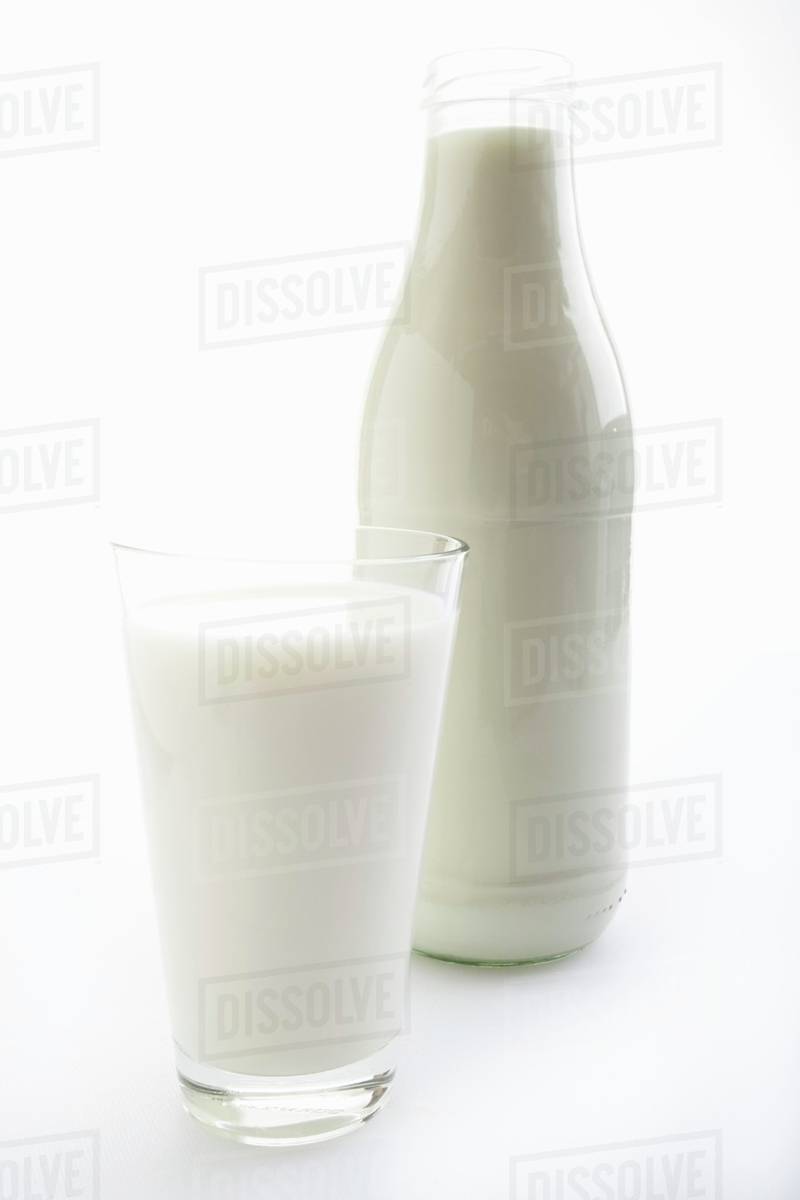 Milk in glass and bottle Stock Photo Dissolve