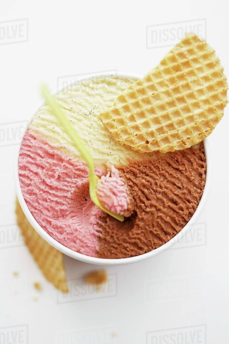 Neapolitan ice cream in tub Stock Photo Dissolve