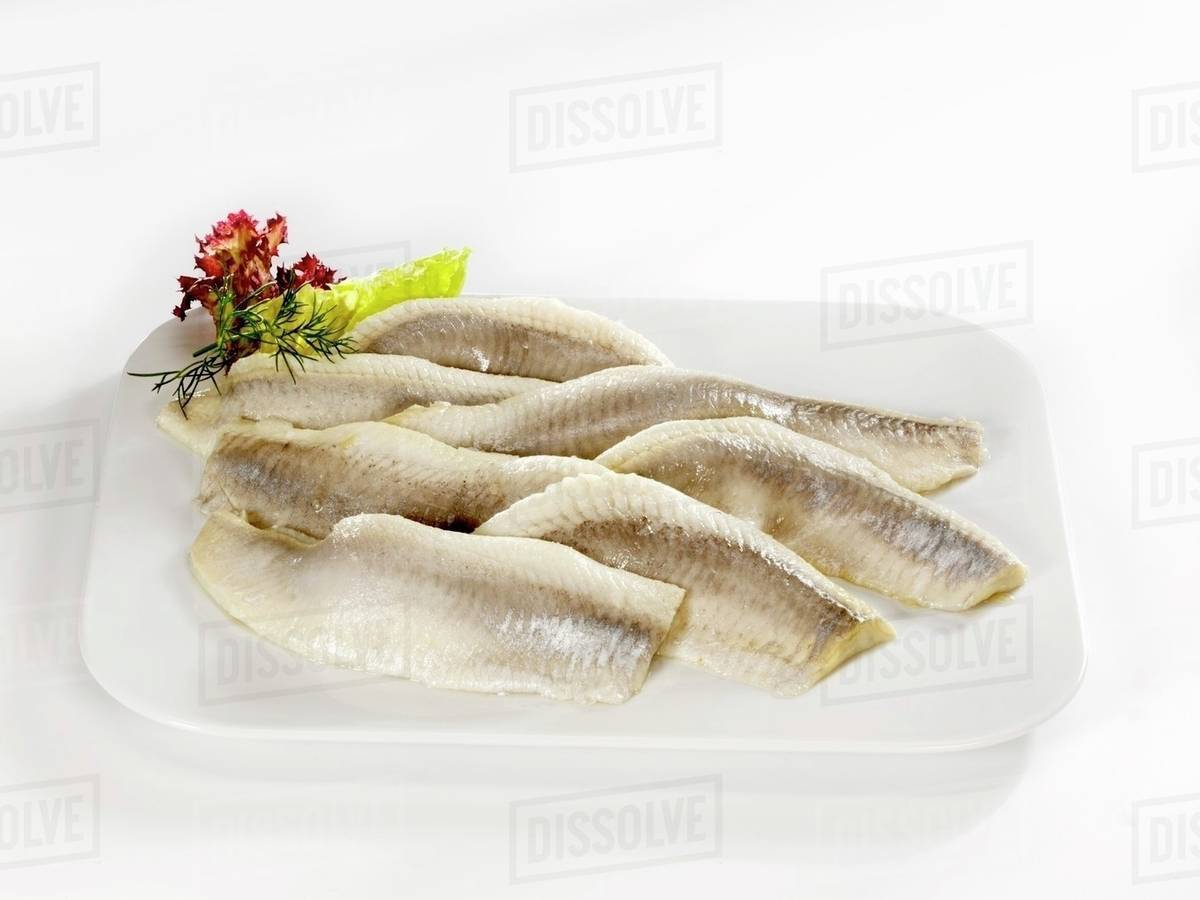 Matjes herring fillets on a platter Stock Photo Dissolve