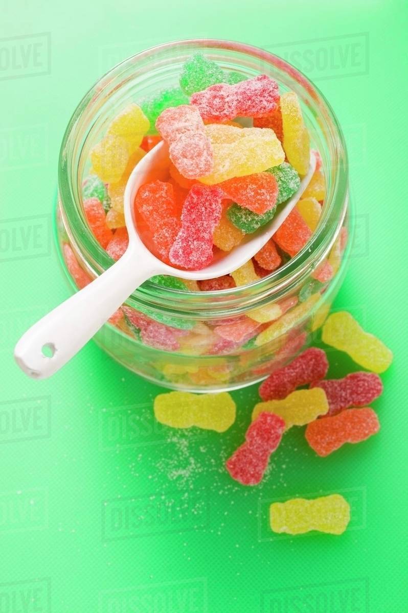 Sour Sweets (fruity jelly sweets, USA) in storage jar Stock Photo