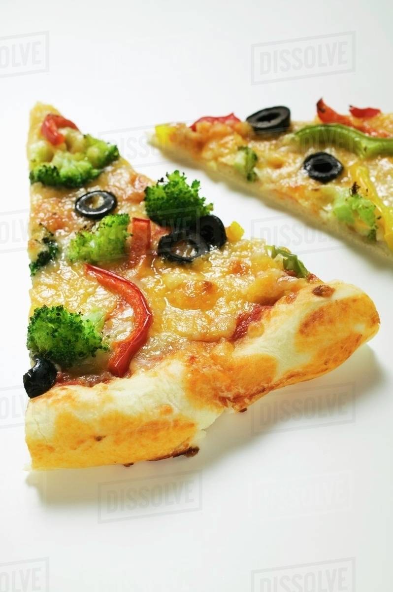 Two slices of Americanstyle vegetable pizza Stock Photo Dissolve