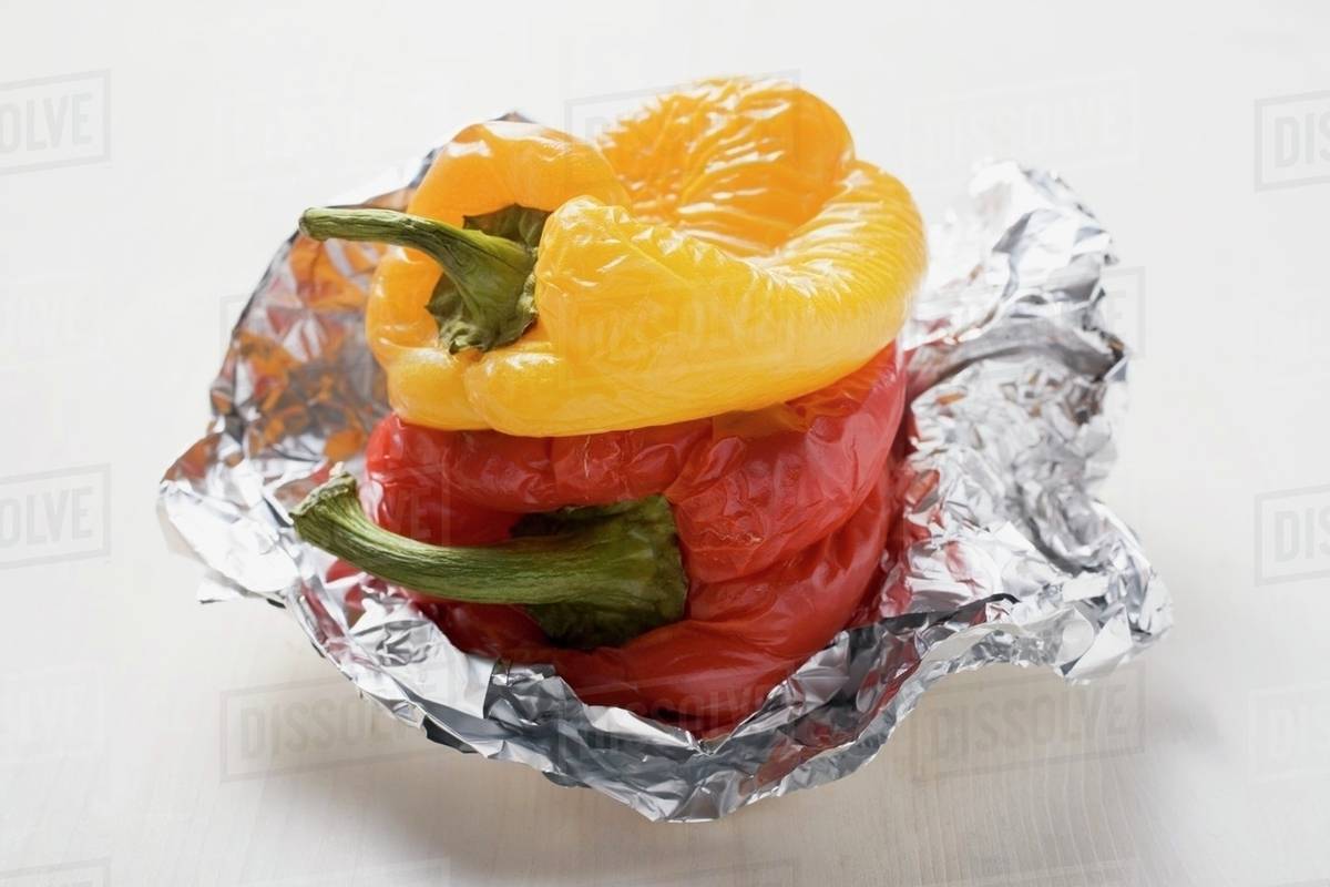 Grilled peppers on aluminium foil Stock Photo Dissolve