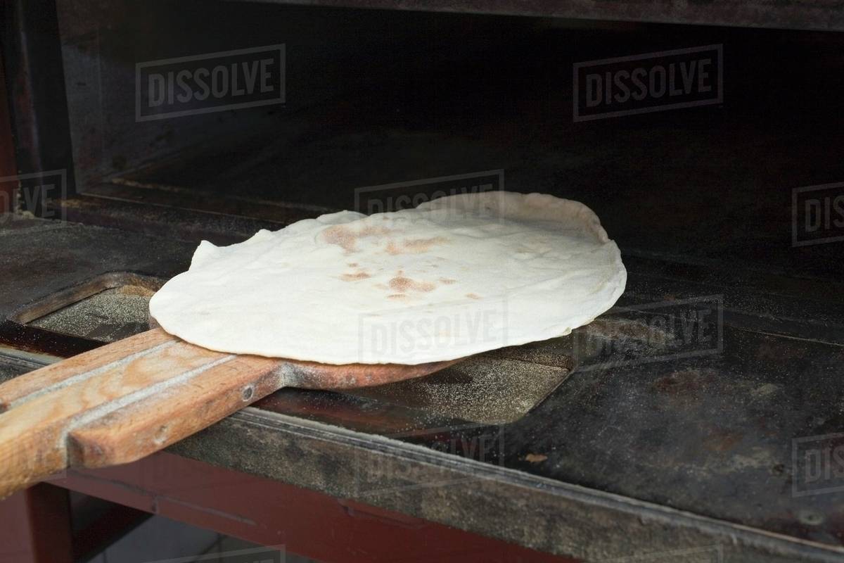 Flatbread in the oven Stock Photo Dissolve
