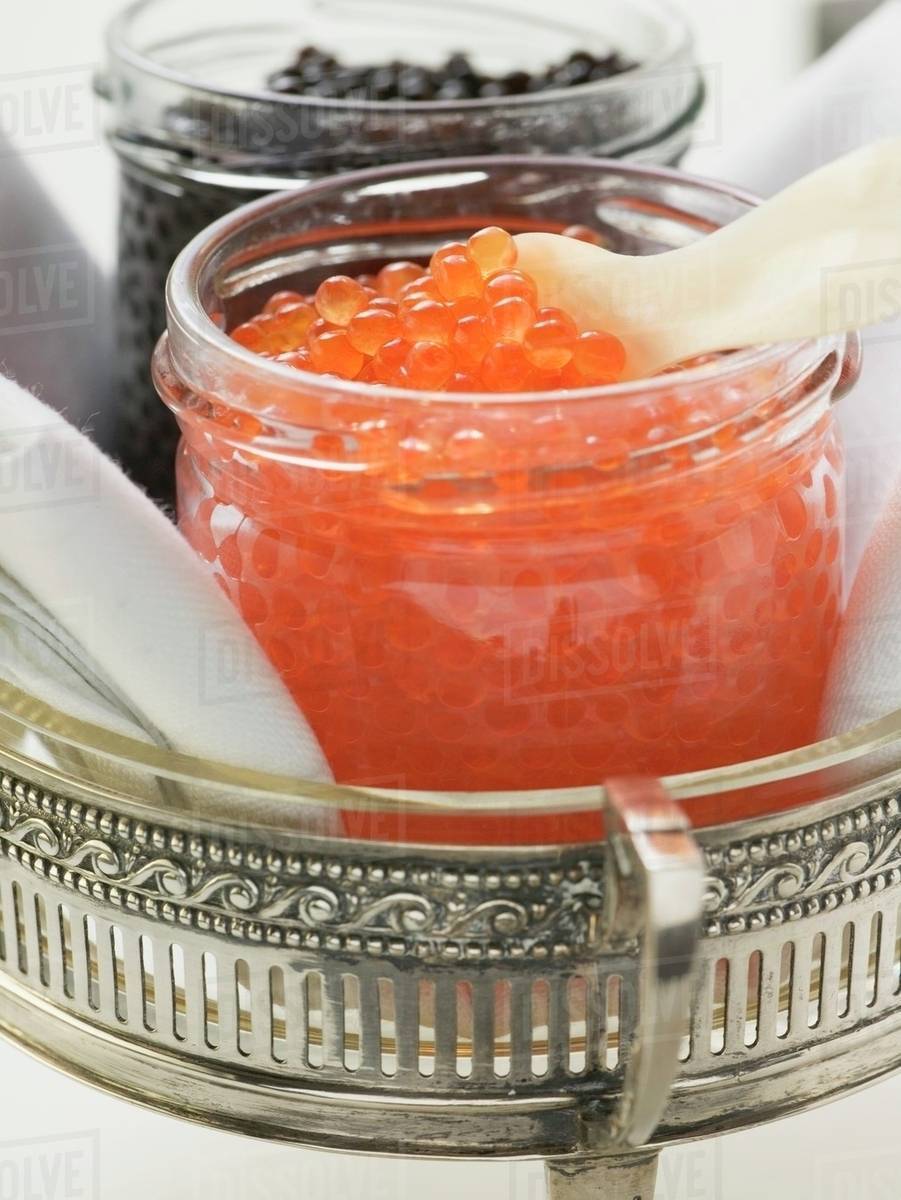 Black caviar and Keta caviar in jars - Stock Photo - Dissolve