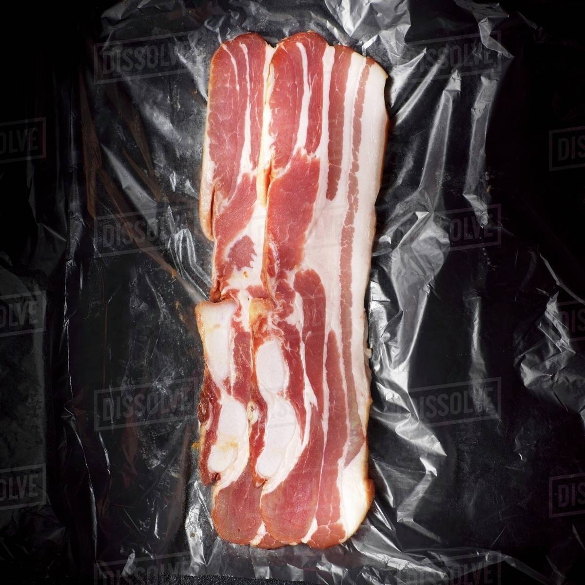 Rashers of bacon (overhead view) Stock Photo Dissolve