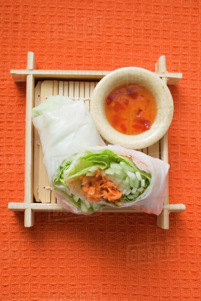 Vietnamese rice paper rolls with vegetables and spicy dip Stock Photo