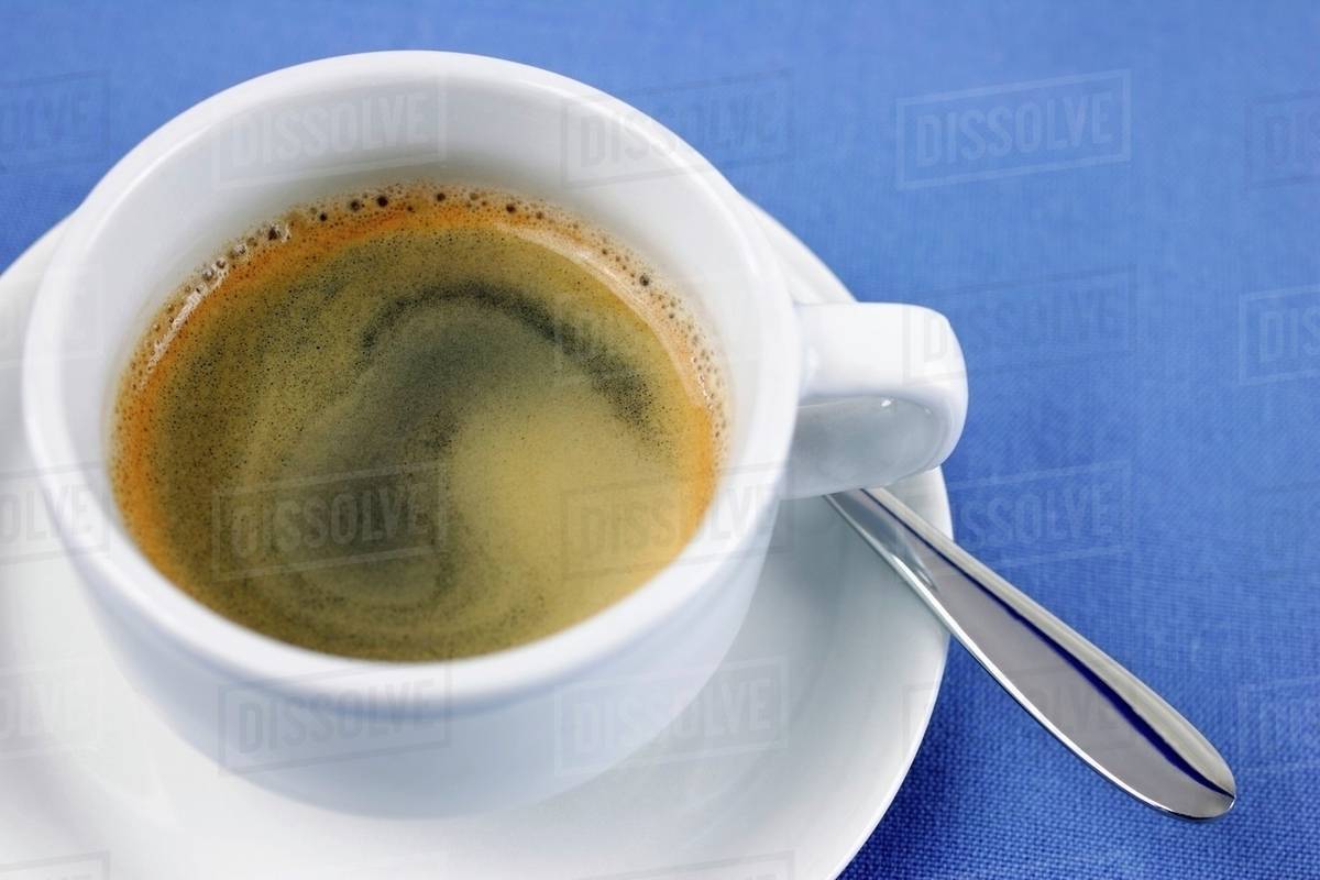 Creamy espresso in cup Stock Photo Dissolve