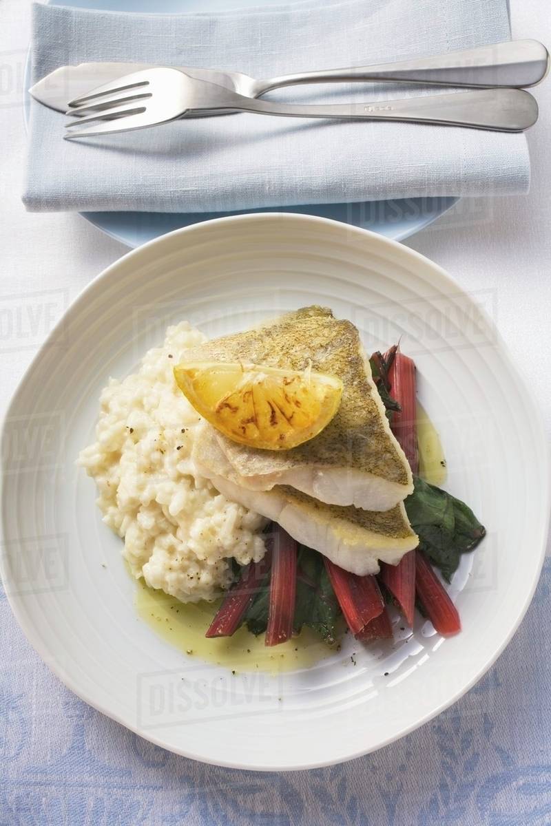 Sea bass fillets with risotto and red chard Stock Photo Dissolve