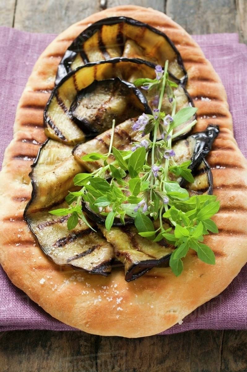 Pizza bread with grilled aubergines Stock Photo Dissolve