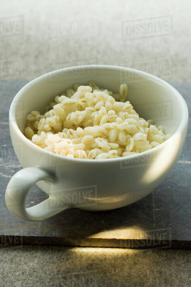 Cooked barley in cup Stock Photo Dissolve