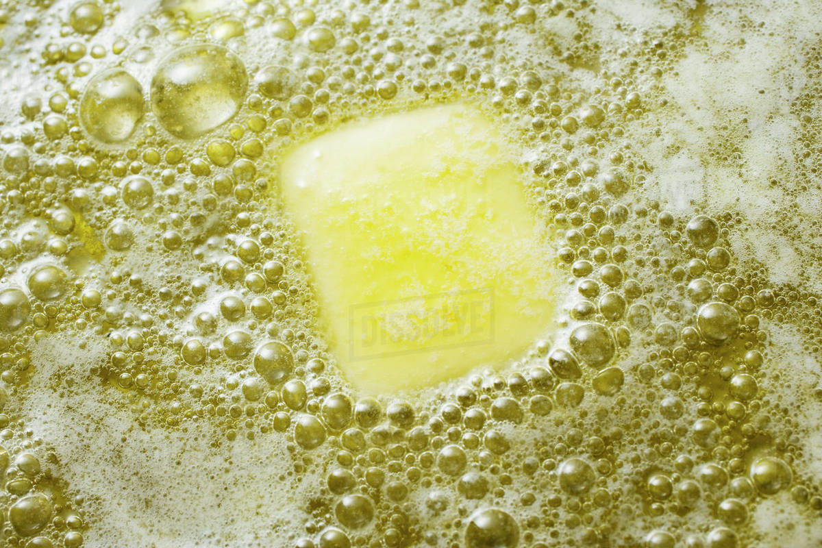 Heating butter and oil in frying pan Stock Photo Dissolve