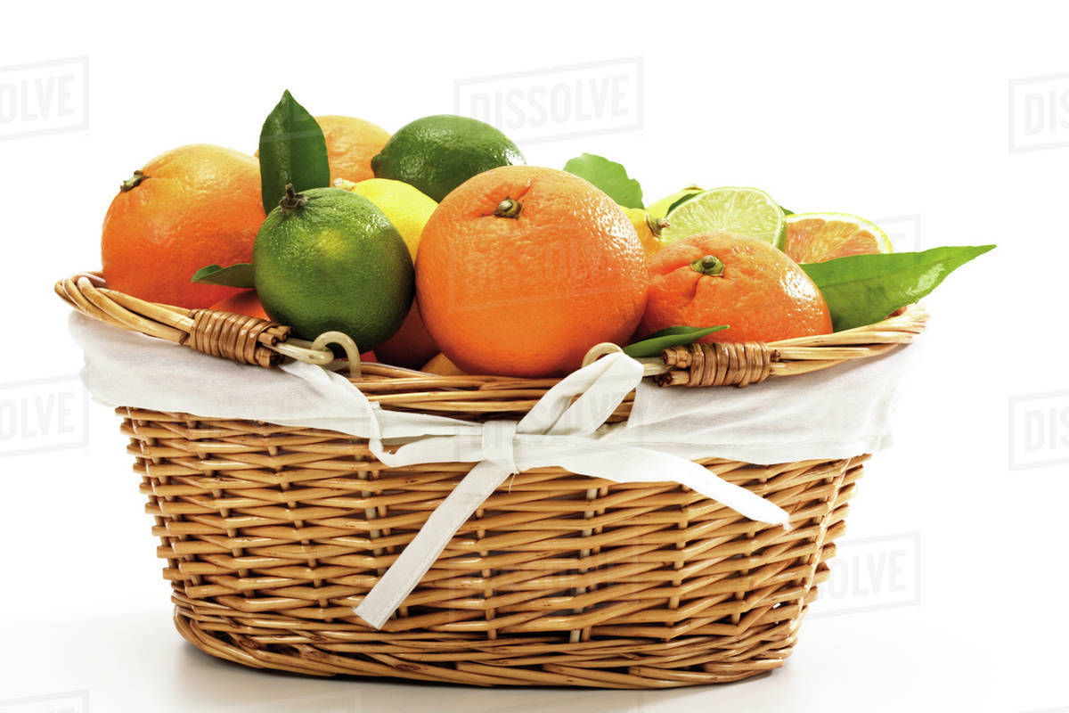 Various citrus fruits in basket Stock Photo Dissolve