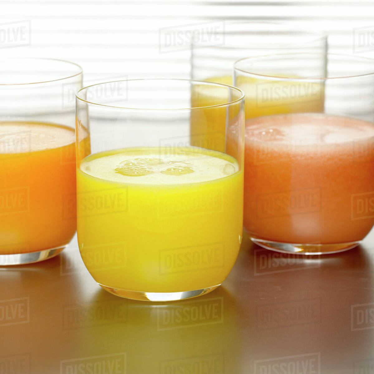Pineapple juice, orange juice and grapefruit juice in glasses, closeup