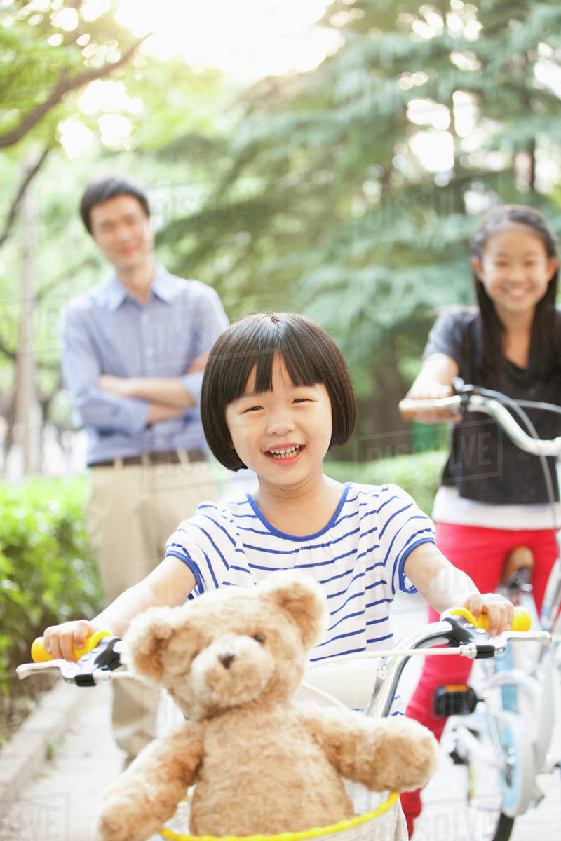 Young Girl Riding Her Bicycle with Her Family Royalty-free stock photo