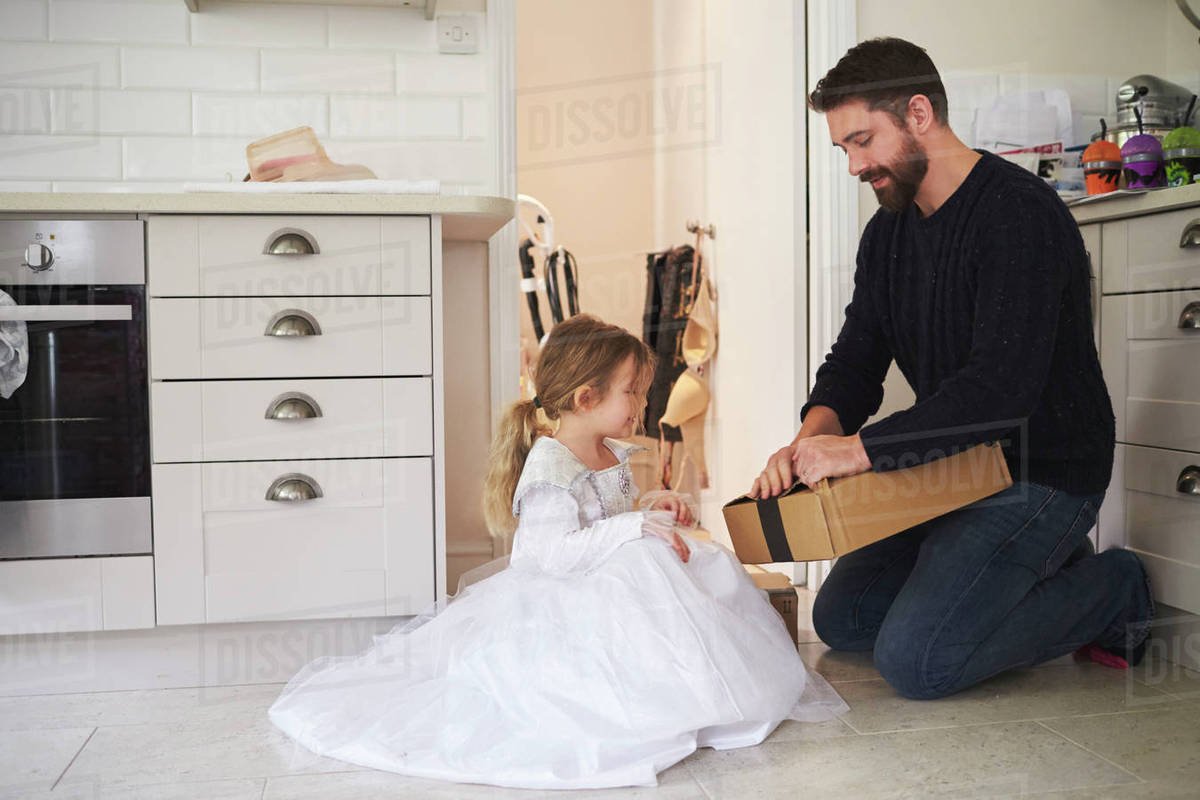 Father And Daughter Opening Home Delivery Package Stock Photo Dissolve