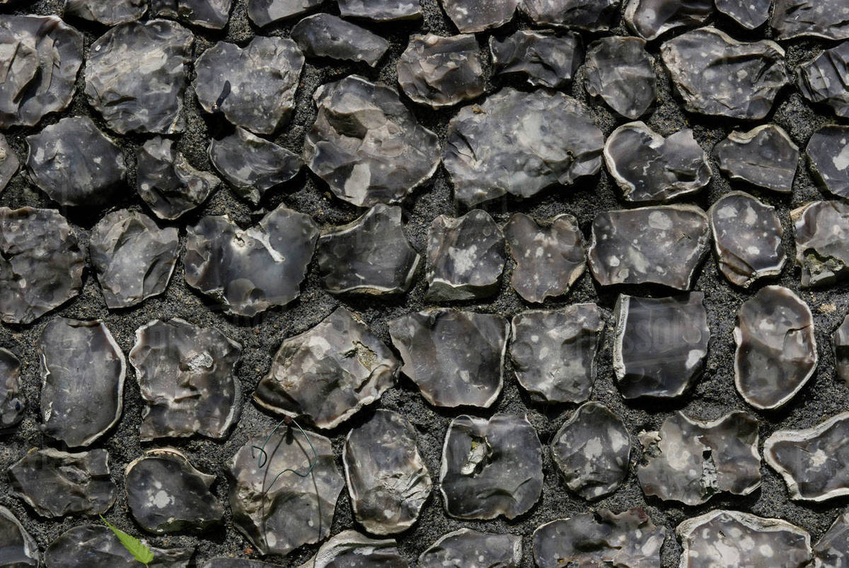 Detail of a polished flint wall - Stock Photo - Dissolve