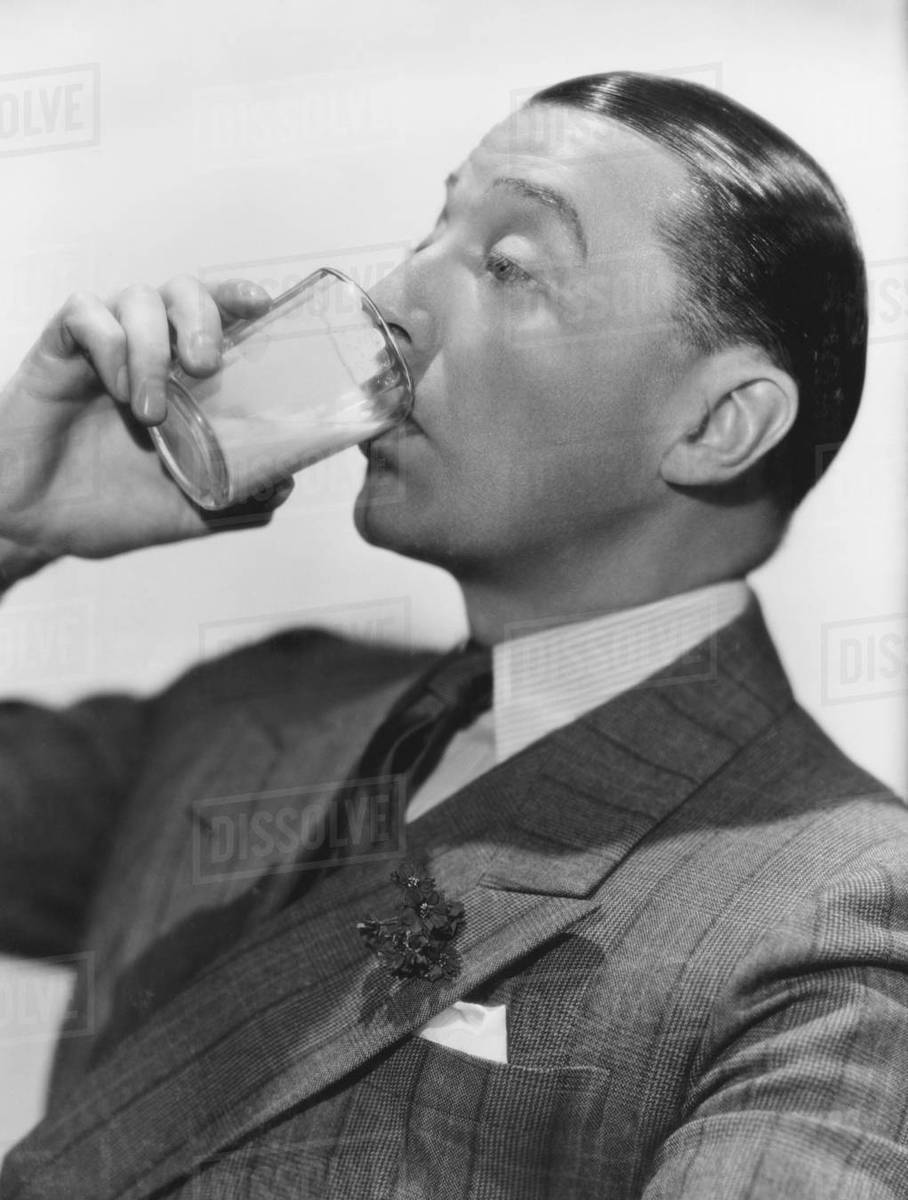 Man drinking beverage Stock Photo Dissolve