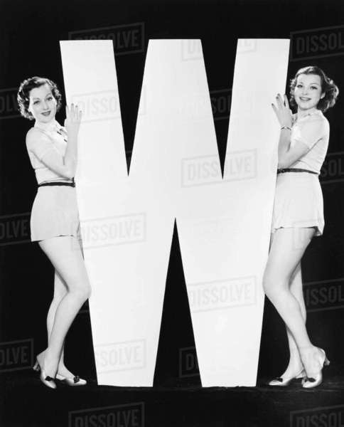 Women posing with huge letter W - Royalty-free Stock Photo | Dissolve