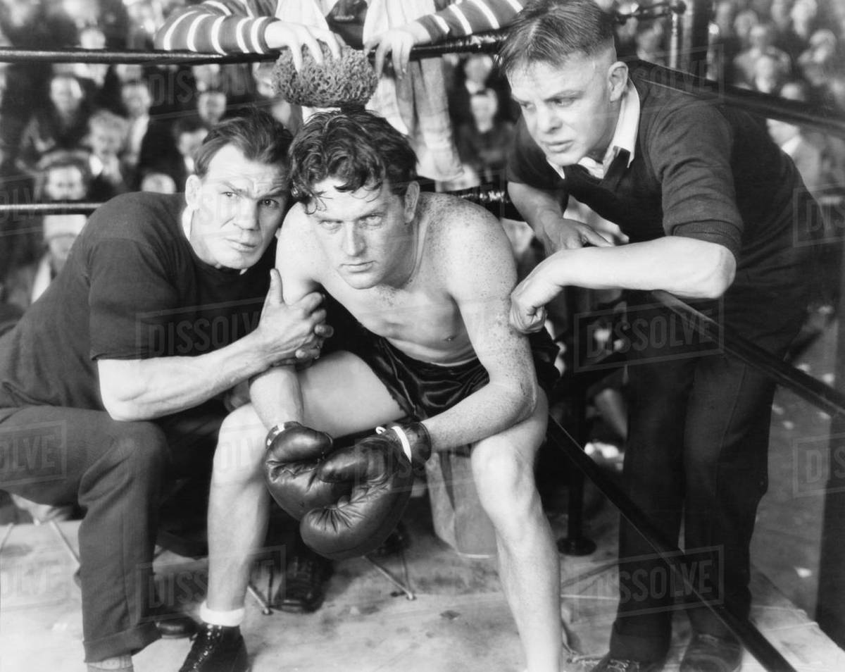 Boxer in corner with trainers Stock Photo Dissolve