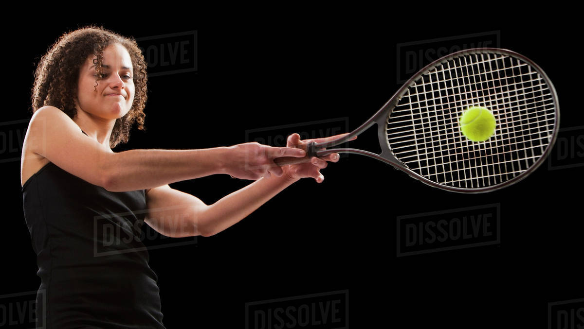 Caucasian tennis player hitting the tennis ball Stock Photo Dissolve