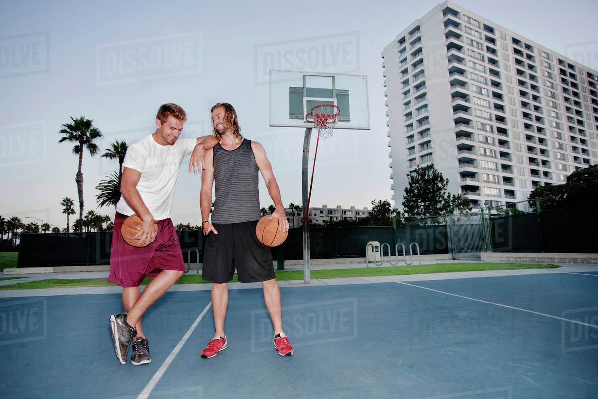 Caucasian men standing on basketball court - Royalty-free Stock Photo ...