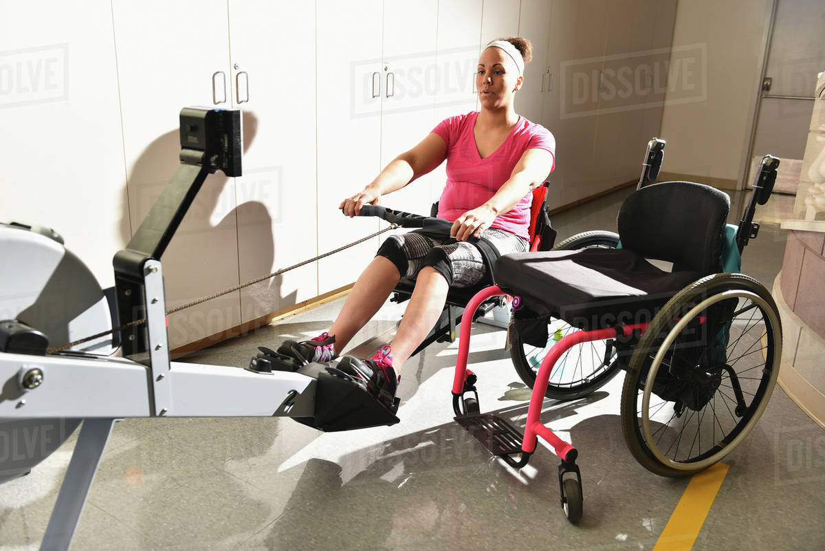 Paraplegic woman working out in physical therapy Royalty-free
