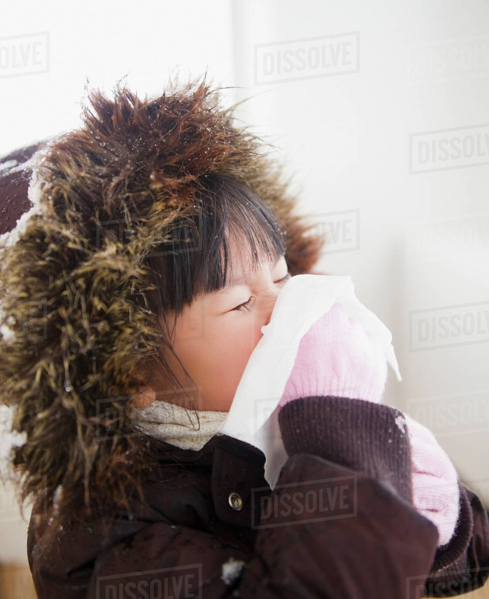 Chinese girl in coat blowing nose Stock Photo Dissolve