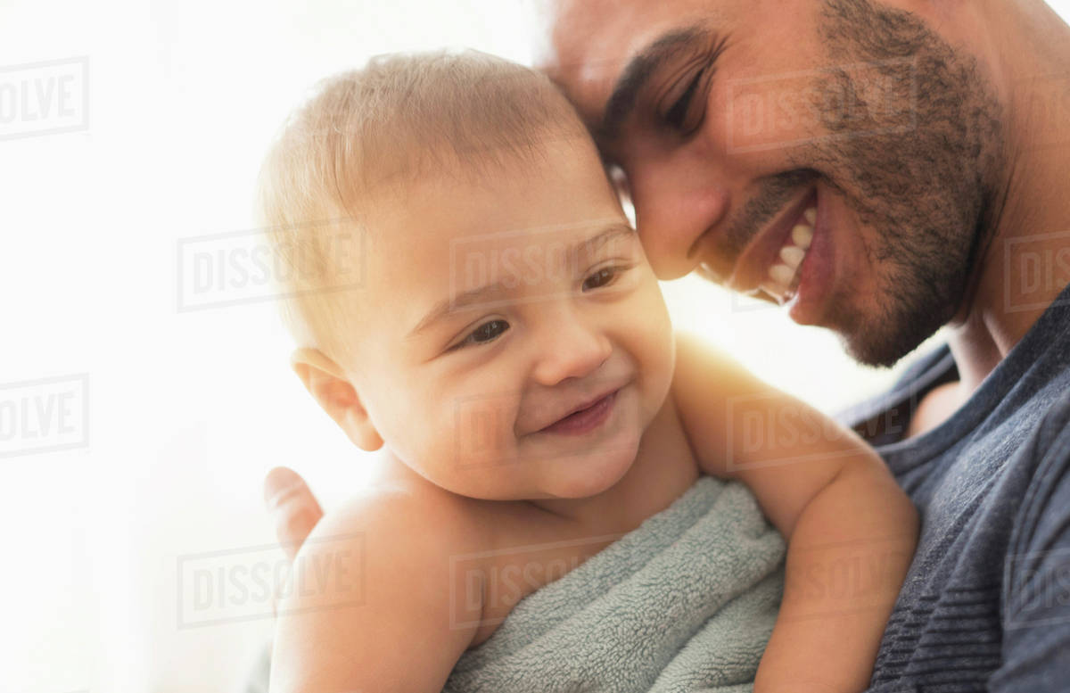Father drying baby son with towel after bath Royalty-free stock photo