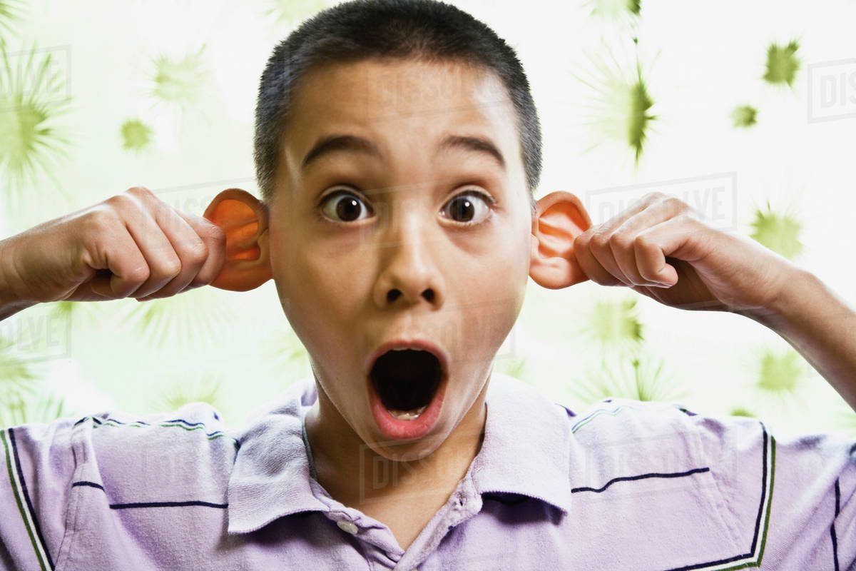 Asian boy pulling on ears Stock Photo Dissolve