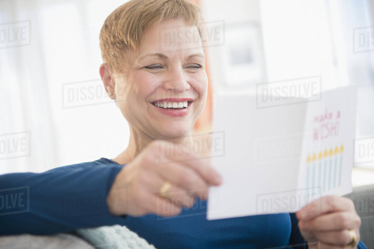 Caucasian woman reading birthday card D5_5_5 Caucasian woman reading birthday card D5_5_5