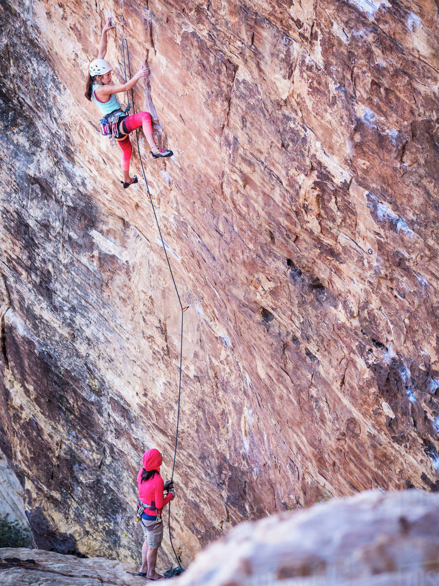 Mother belaying daughter rock climbing on cliff Stock Photo Dissolve