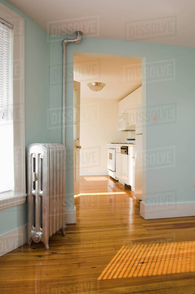 Empty Room In Apartment With Hardwood Floor And Heater Stock Photo Empty Room In Apartment With Hardwood Floor And Heater