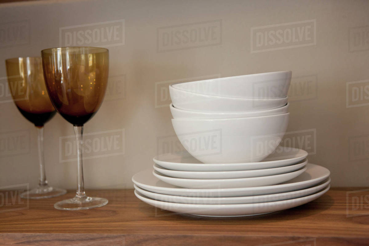 Bowls with plates and glasses on shelves in Stock Photo Dissolve