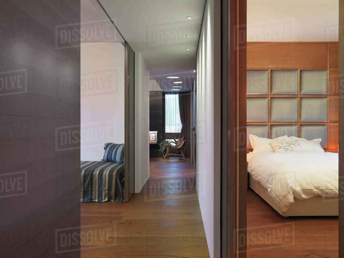 Hardwood hallway between bedroom and living room in modern home ...
