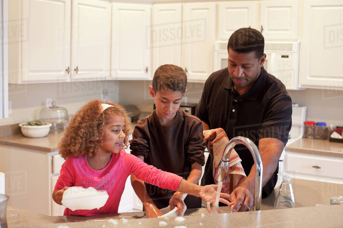 Family washing dishes together Stock Photo Dissolve