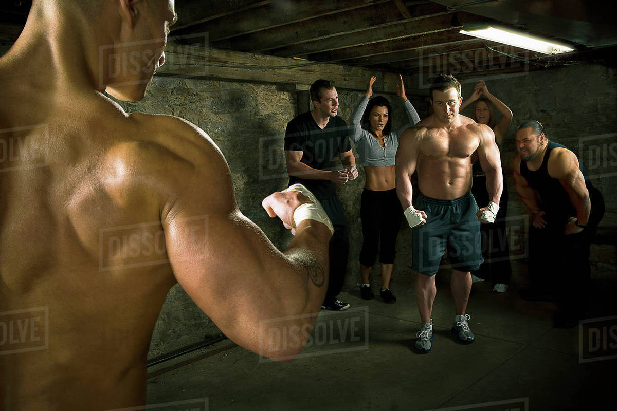 People watching two men boxing without gloves Stock Photo Dissolve