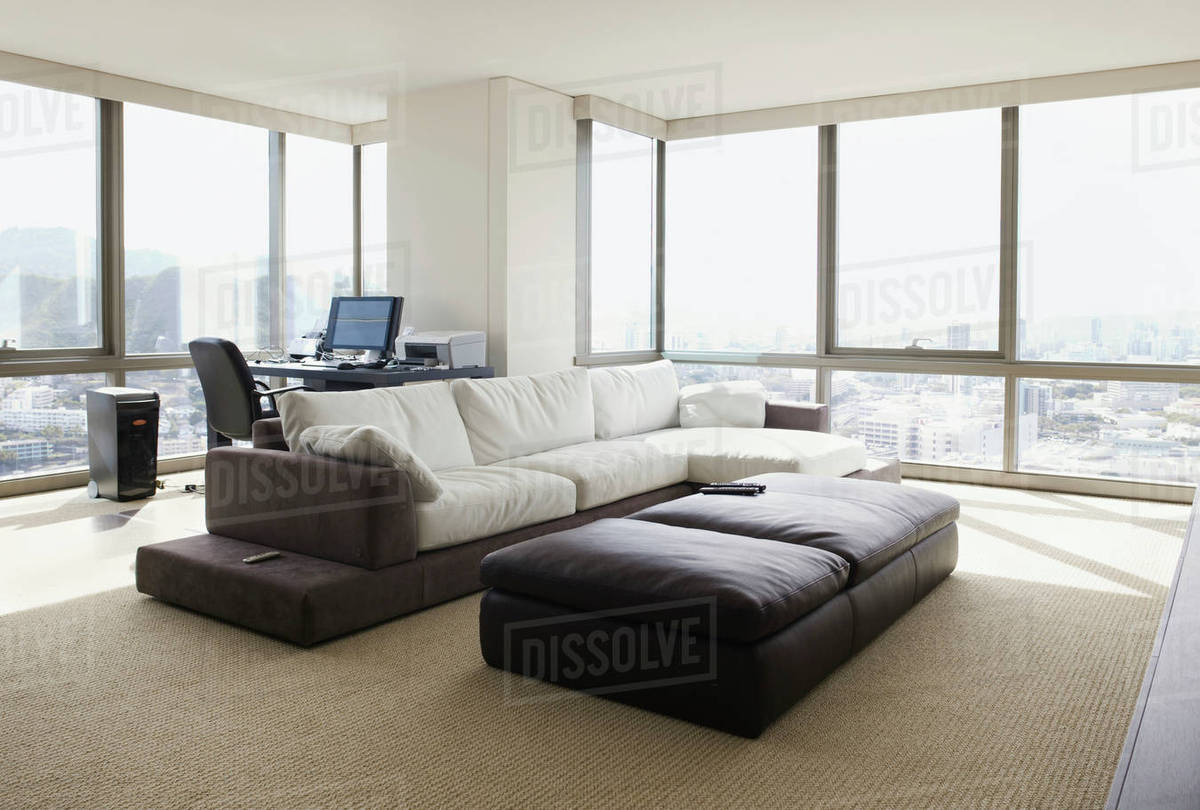 Living room and home office in luxury highrise apartment - Stock Photo