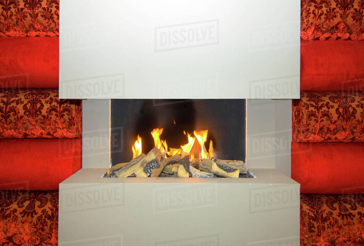 Open gas fire, in a smooth stone fireplace Stock Photo Dissolve