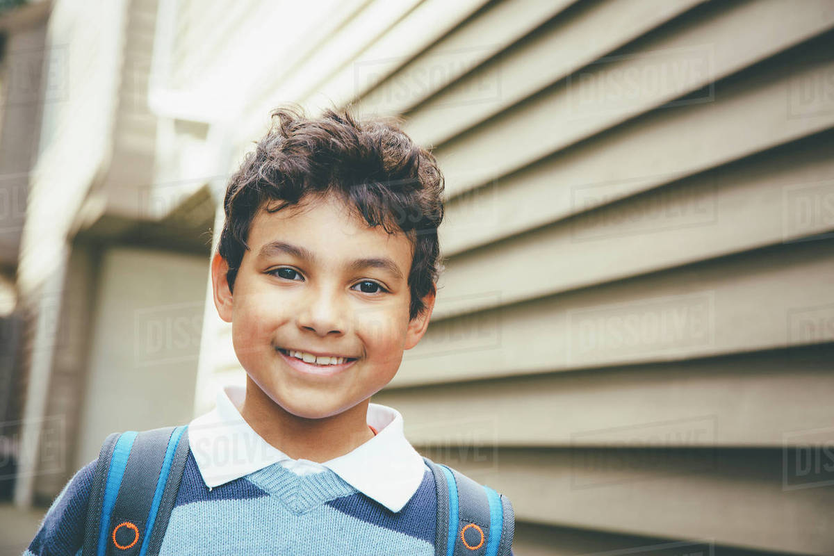 Mixed Race Boy Smiling Near House Stock Photo Dissolve