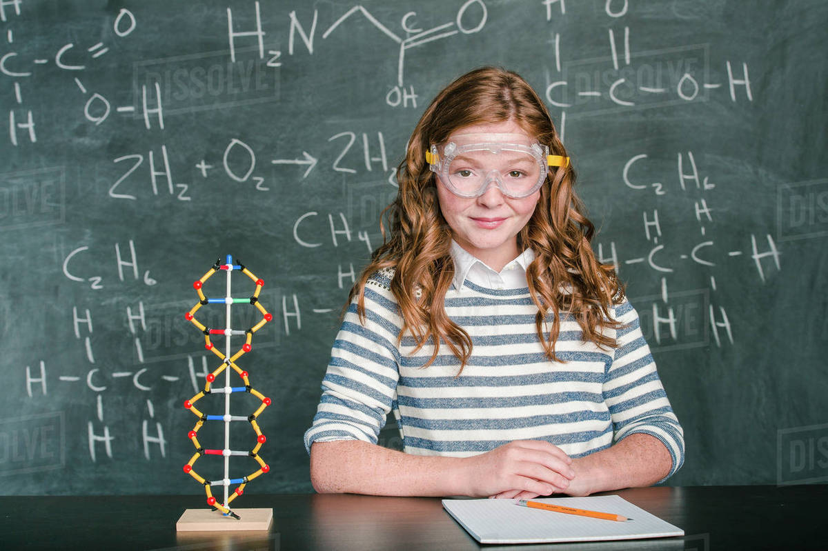 Caucasian student wearing safety goggles in science class Stock Photo