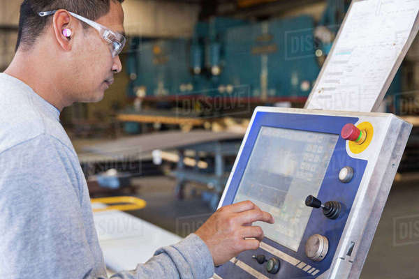 Asian worker using control panel in factory - Royalty-free Stock Photo ...