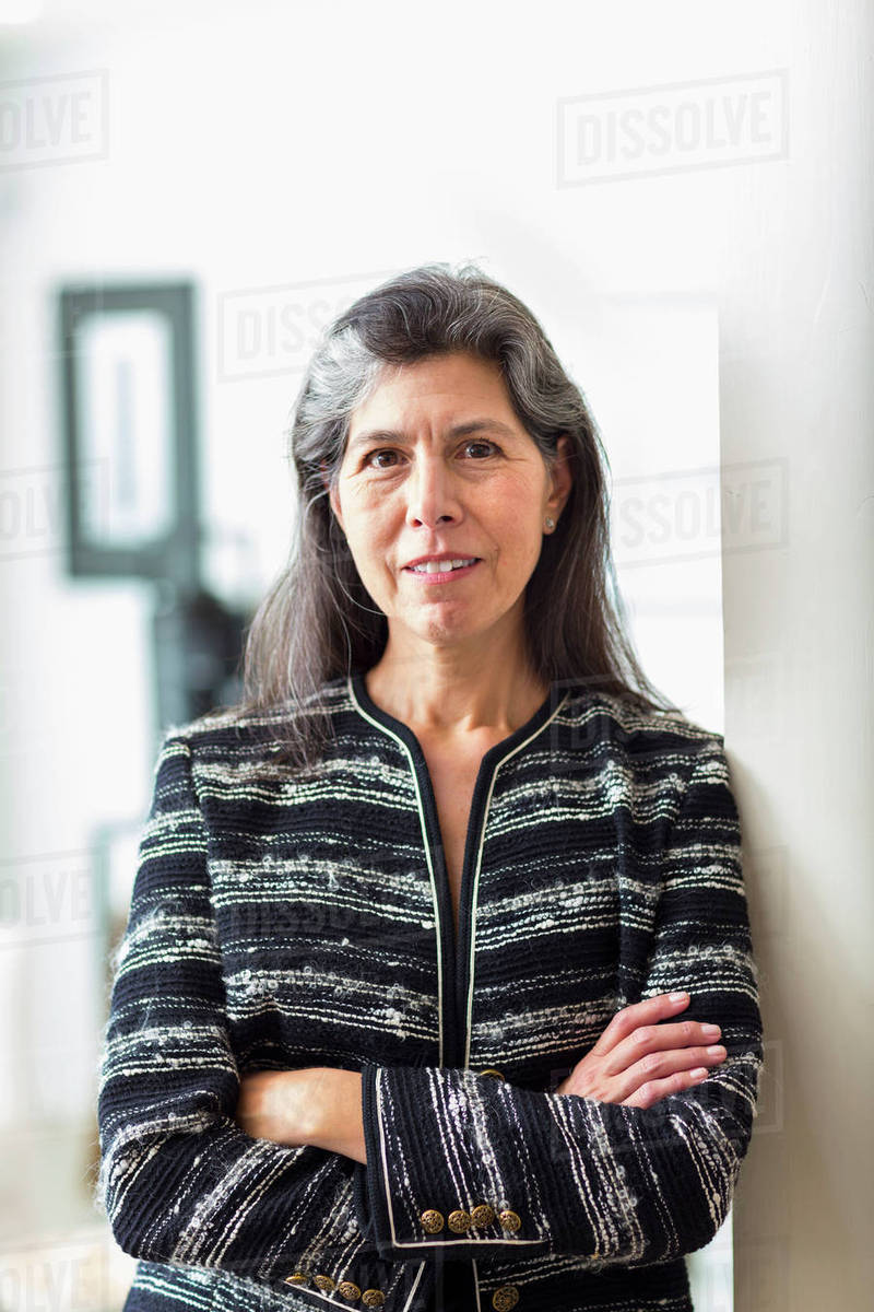 Portrait of Hispanic woman leaning on wall Royalty-free stock photo