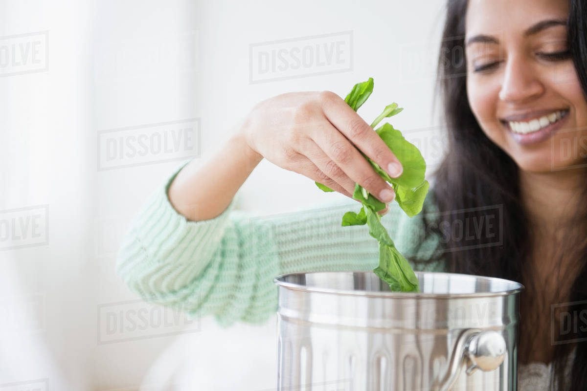 Asian woman composting lettuce Stock Photo Dissolve