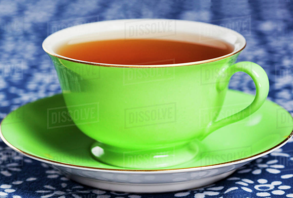 Close up of tea in green china tea cup Stock Photo Dissolve