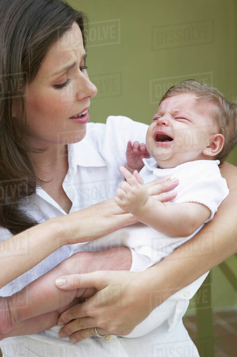 Mother Comforting Crying Baby Stock Photo Dissolve
