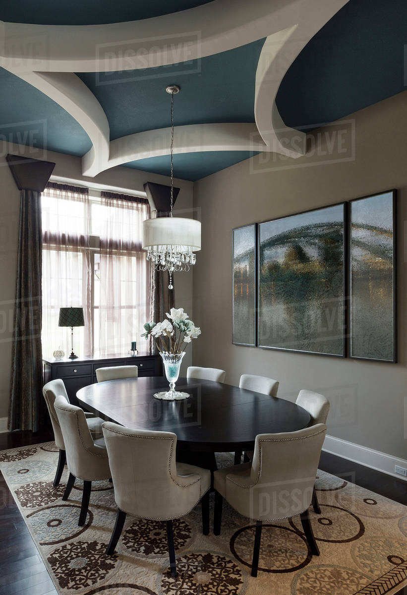 Table and chairs with paintings in dining room Stock Photo Dissolve