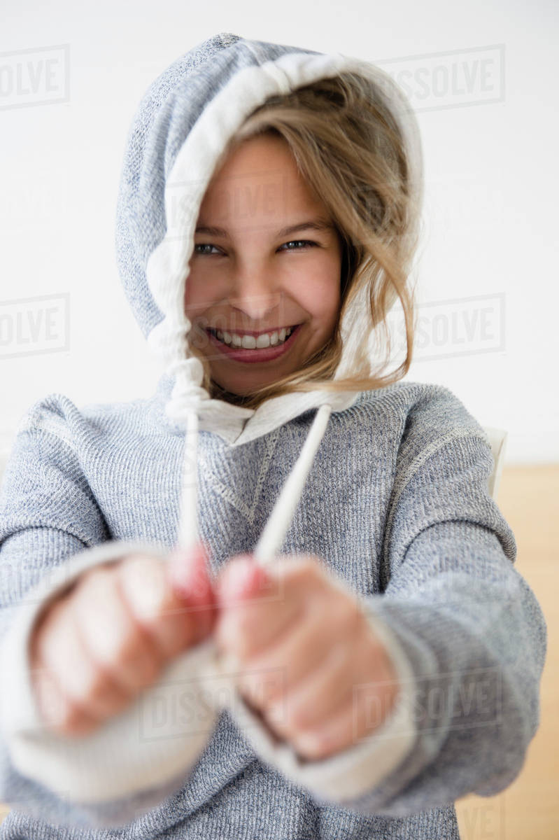 Caucasian girl pulling strings of hood - Royalty-free Stock Photo ...