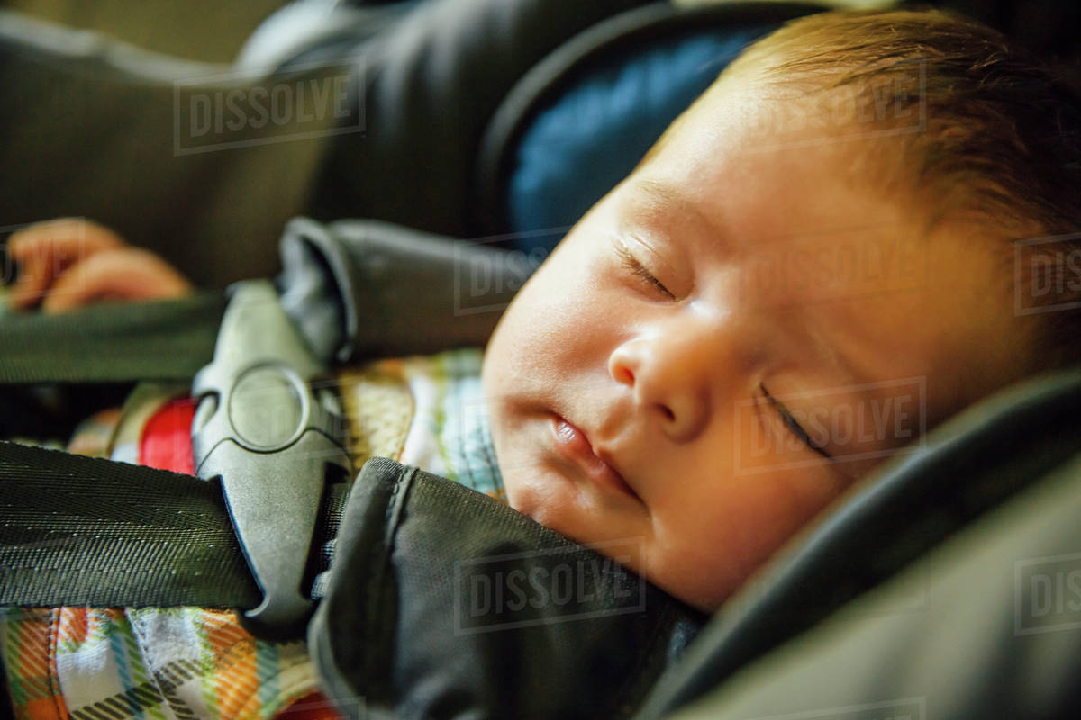 Caucasian baby boy sleeping in car seat Stock Photo Dissolve