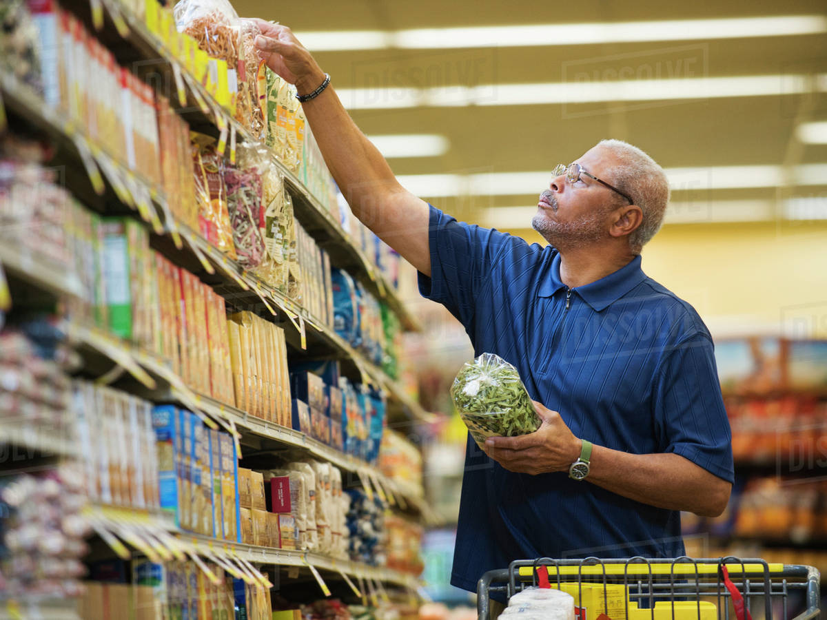 African American man shopping in grocery store Stock Photo Dissolve